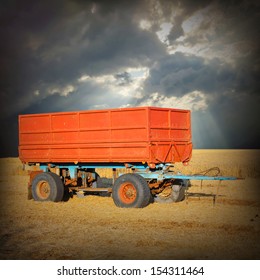 A Empty Tractor Trailer On A Wheat Field.