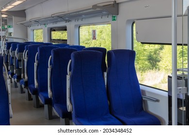 An Empty Train Car With Blue Upholstered Chairs. Travel Concept