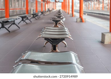 Empty Train Station Platform with Benches and Symmetrical Perspective