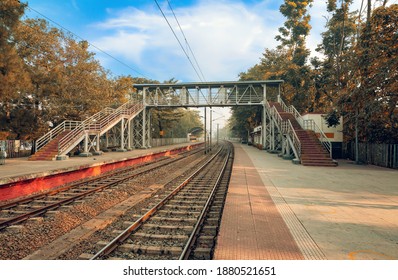 Empty train station platform with railway tracks at sunrise at Kolkata India - Powered by Shutterstock