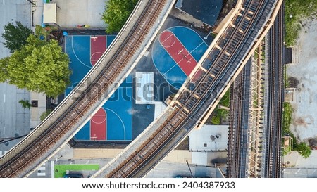 Empty train track, railroad transit, transportation bridges above basketball courts aerial, Chicago IL