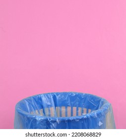 Empty Trash Bin With Package On Pink Background