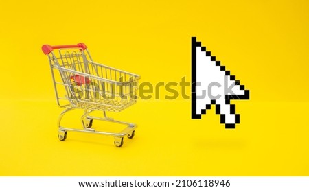 Empty trolley cart and mouse cursor on yellow surface. Online shopping concept