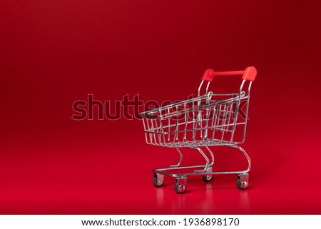 Empty trolley isolated on red background. shopping online and service  home delivery.