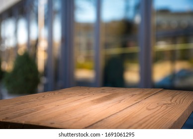 Empty tropical wood table and blurred garden cafe light background. product display template.Business presentation - Shutterstock ID 1691061295