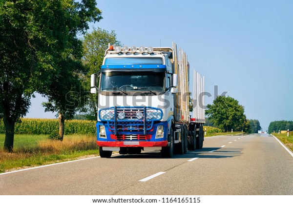 Empty truck at the road in Poland. Lorry\
transport delivering some freight\
cargo.