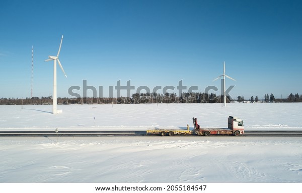Empty truck trailer moving on snowy winter  road\
aerial drone view