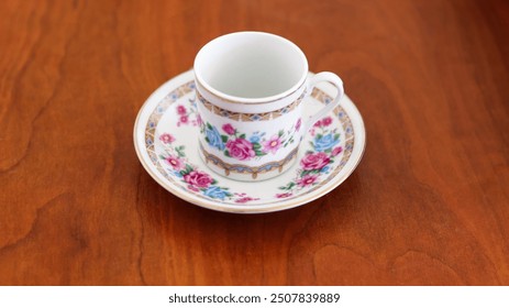 Empty Turkish coffee cup on brown wooden table. Porcelain cup with rose pattern on it. - Powered by Shutterstock