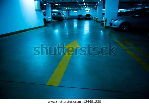 Empty underground\
parking garage at night