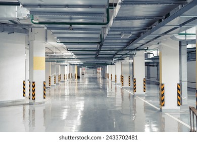 Empty underground parking garage with symmetrical concrete floors and columns - Powered by Shutterstock