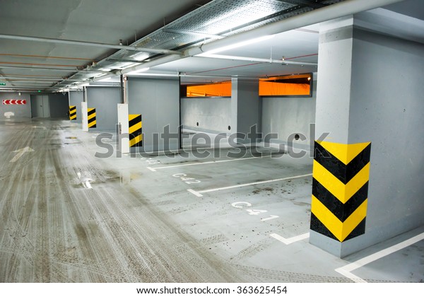 Empty underground\
parking with lots for\
cars