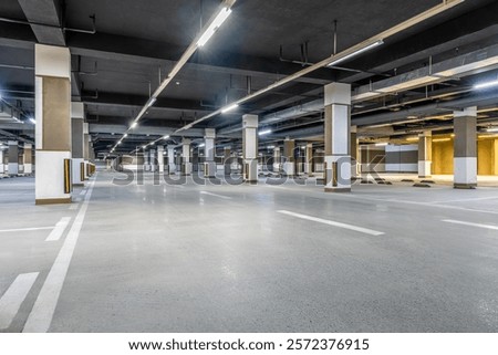 Empty underground parking lot with many pillars and lines