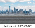 Empty urban asphalt road exterior with city buildings background. New modern highway concrete construction. Concept of way to success. Transportation logistic industry fast delivery. New York. USA.