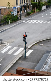 Empty urban intersection with traffic light and crosswalk in Paris street scene.