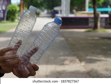 Empty used drinking water plastic bottles in hands. It can be reused or separated before throwing to be recycling garbage. Reuse Reduce Recycle concept. Stop environmental problem. Global warming.