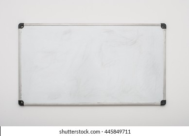Empty used whiteboard (magnetic board) isolated on white