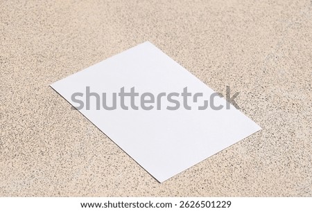 empty vertical paper poster mockup on concrete stone floor or pavement outdoors. Flat lay, top view. For advertising, brand design, stationery presentation.