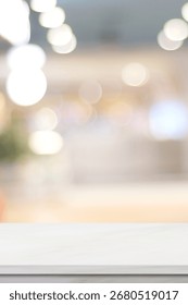 Empty vertical white table top, counter, desk background over blur  bokeh background, White marble stone table, shelf and blurred kitchen restaurant for food, product display mockup, template