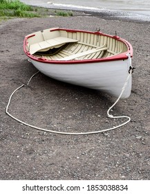 Empty Vintage Wooden Row Boat On The Beach