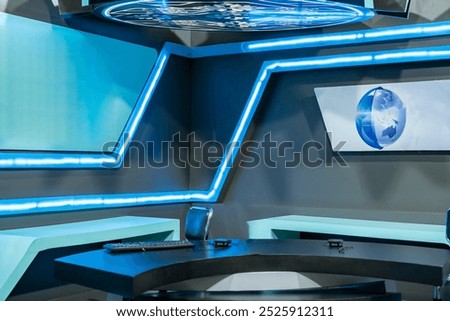 Empty virtual tv studio set designed with blue neon lights, featuring a desk and a world map background, ready for a news anchor to present breaking news