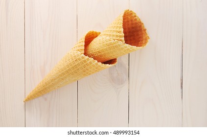 Empty Waffle Cone On White Wooden Background - Top View