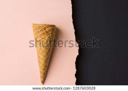 Empty waffle ice cream cone on dutone peachy pink black paper background with torn edge. Styled image mockup flyer poster template for cafe menu collage elements artwork text lettering. Funky