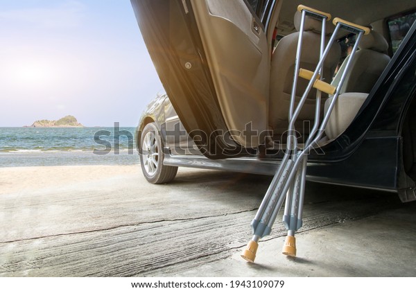 Empty walking stick or staff cane for patient\
or senior or elderly people on car with beach background,healthy\
medical concept\
