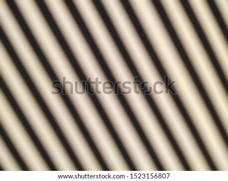 Empty wall with window shadow. Abstract background of a wall with shadows from the window Thin lines of light on the wall