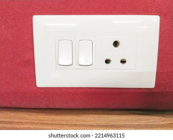 Empty Wall With Wooden Floor. On The Wall Power Outlet And Light Switch