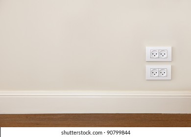 Empty Wall With Wooden Floor And Power Outlet