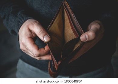 An Empty wallet in the hands of a young man - Shutterstock ID 1900840984