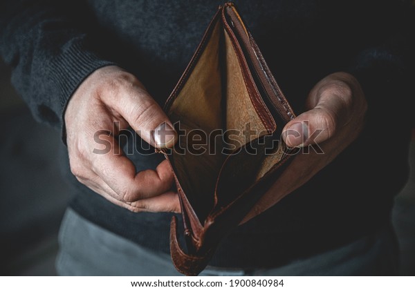 An Empty wallet\
in the hands of a young man