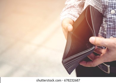 Empty Wallet (no Money) In The Hands Of An Man. Cost Control Expenses Poverty   In Concept