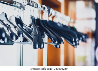 Empty Wardrobe Stand With Black Hangers At Business Event Venue. Empty Clothing Rack At The Theatre Or Business Party.