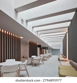 Empty warehouse interior with high ceiling, exposed services, concrete structure, and organized industrial space.