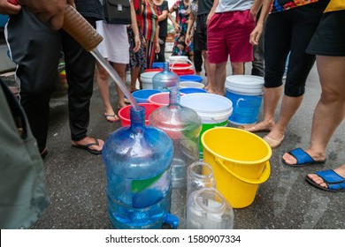 Empty Water Buckets Waiting For Fresh Water From Emergency Mobile Tank Truck