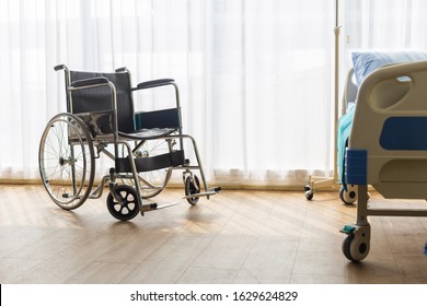 Empty wheelchair and bed in patient room, in hospital. - Powered by Shutterstock