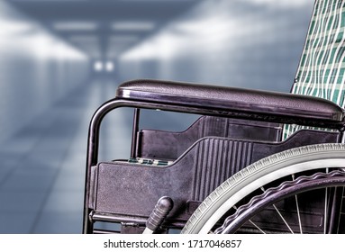 Empty Wheelchair In Hallway Of Hospital Or Retirement Nursing Care Home With Copy Space. Concept Of Sickness, Loneliness, Neglect, Isolation Due To Pandemics, Outbreaks, Epidemics, Illness, Lockdowns.