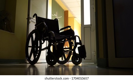 Empty Wheelchair Parked In Hospital Hallway