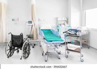 Empty wheelchair parked in hospital room with beds and comfortable medical equipped in a modern hospital