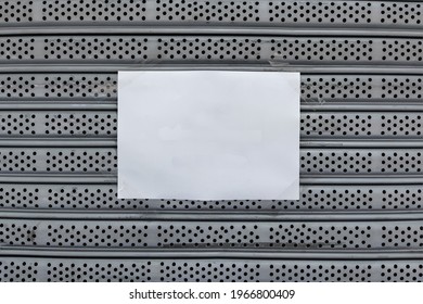 Empty White A4 Paper Sticked By Clear Adhesive Tape On Old Gray Metal Rolling Door Background. 