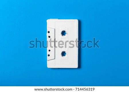 empty white audio cassette on a blue background