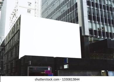 Empty White Billboard On City Building. Public Ad And Commercial Concept. Mock Up 