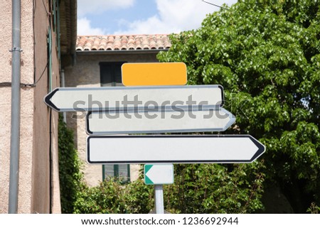 Empty white boards pointing towards different directions.