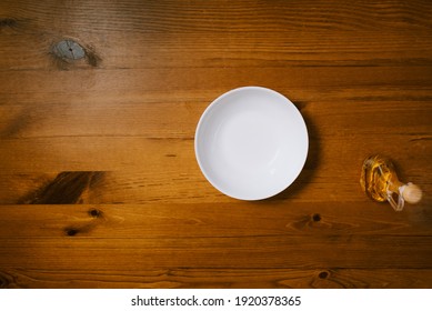 Empty White Bowl On A Wooden Table