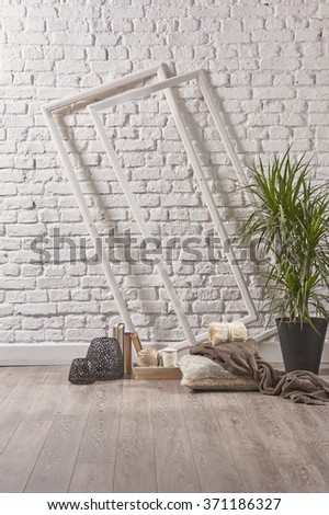 Empty white brick wall with frame border wooden floor and flower
