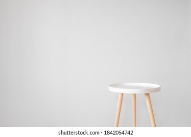 Empty White Coffee Table In Front Of Grey Wall. Scandinavian Style, Minimalism In House, Tranquil Living, Backdrop And Copy Space For Advertising And Inserting Objects