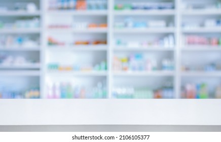 Empty White Counter With Pharmacy Drugstore Shelves Blurred Background