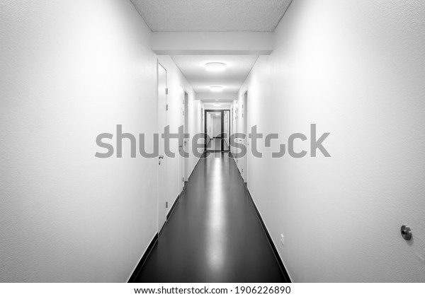 Empty white hallway in\
black and white