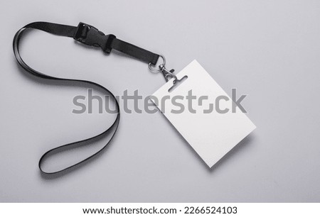 Empty white ID card badge mockup with black belt on gray background. Staff identity name tag. Space for text and design. Top view. Flat lay